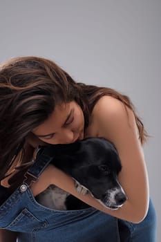 Tender moment of affection between a young woman and her dog, highlighting the special bond between humans and their pets