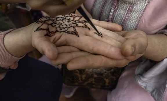 Detail of hand decoration with brown henna, art