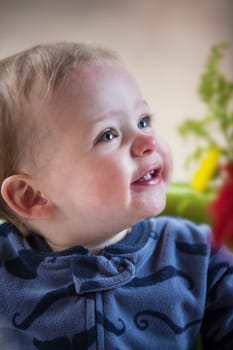 A little boy smiles for the camera.