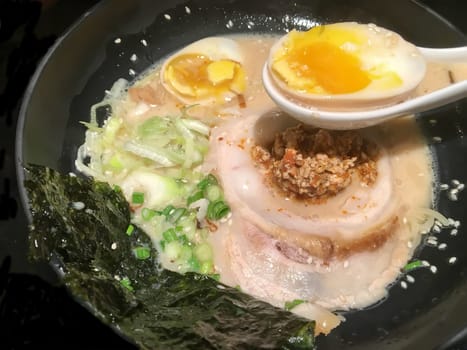 Savor the rich flavors of a perfectly crafted tonkotsu ramen with tender pork, soft-boiled egg, and fresh scallions.