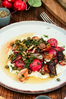 Roasted radish salad or piccata on a concrete kitchen table. Vegetarian piccata, Italian food.