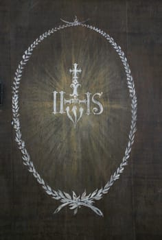 Christ's monogram IHS on the altar in parish Church of Our Lady of snow in Kamensko, Croatia