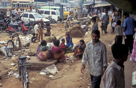 poor people and children with some food on a square in the city of Chennai in Province Tamil Nadu in India.  India, Chennai, April, 1998