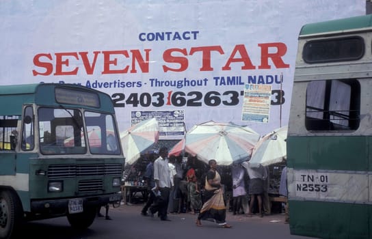 a public Bus Station in front of a advertising of Seven Star in the city of Chennai in Province Tamil Nadu in India.  India, Chennai, April, 1998