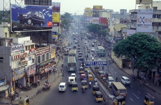 Traffic and pollution with cars, bus amd motorcycle on a mainroad in the city of Chennai in Province Tamil Nadu in India.  India, Chennai, April, 1998