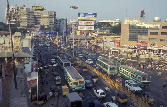 Traffic and pollution with cars, bus amd motorcycle on a mainroad in the city of Chennai in Province Tamil Nadu in India.  India, Chennai, April, 1998