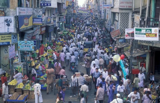 Traffic and pollution with cars, bus amd motorcycle on a mainroad in the city of Chennai in Province Tamil Nadu in India.  India, Chennai, April, 1998
