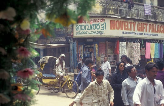 People at Streetmarket and alley in the city of Chennai in Province Tamil Nadu in India.  India, Chennai, April, 1998