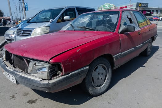 heavily used falling apart neglected taxi car at the sunny summer street of Central Asia in Sokuluk, Kurgyzstan - March 31, 2023