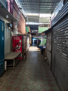 empty narrow passage between trading containers in Dordoi Bazaar in Bishkek, Kyrgyzstan - March 20, 2023