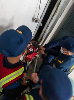 Rescuers from the Ministry of Emergency Situations of Kyrgyzstan break open a metal door to an apartment in an apartment building in Bishkek, Kyrgyzstan April 22, 2023