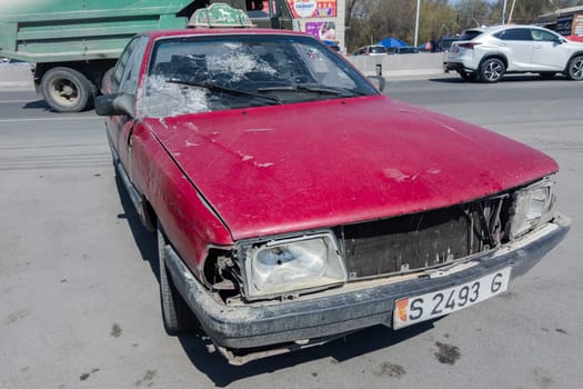 heavily used falling apart neglected taxi car at the sunny summer street of Central Asia in Sokuluk, Kurgyzstan - March 31, 2023