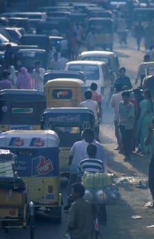 Traffic and pollution with cars, bus amd motorcycle on a mainroad in the city of Chennai in Province Tamil Nadu in India.  India, Chennai, April, 1998