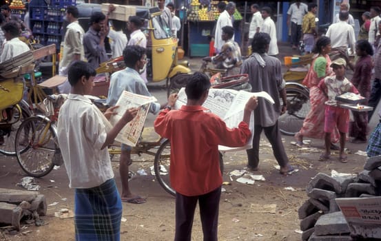 people read Newspapers at a marketstreet in the city of Chennai in Province Tamil Nadu in India.  India, Chennai, April, 1998