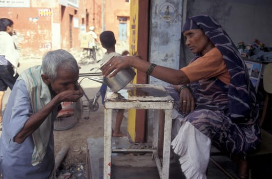 a free public water station for dursty people at a shop by very hot weather in the city of Khajurao in Province Madhya Pradesh in India.  India, Khajurao, April, 1998
