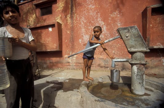 a free public water station for dursty people at a shop by very hot weather in the city of Khajurao in Province Madhya Pradesh in India.  India, Khajurao, April, 1998