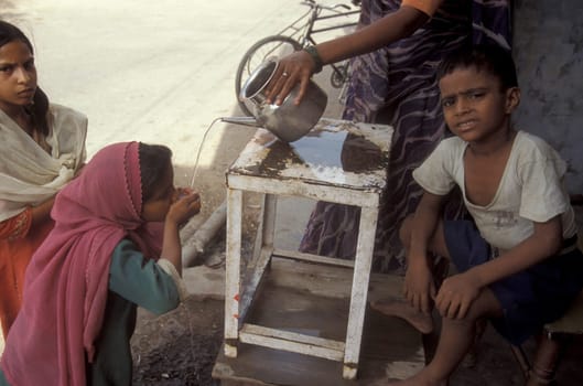 a free public water station for dursty people at a shop by very hot weather in the city of Khajurao in Province Madhya Pradesh in India.  India, Khajurao, April, 1998