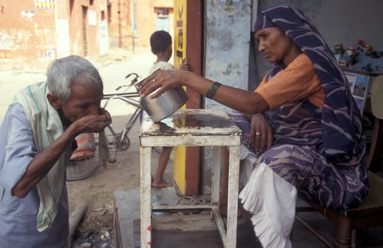 a free public water station for dursty people at a shop by very hot weather in the city of Khajurao in Province Madhya Pradesh in India.  India, Khajurao, April, 1998