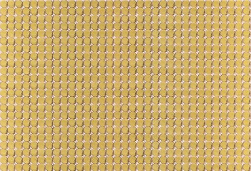 Analog mechanism composed of numerous rows of golden circular cells meticulously aligned to create a visually appealing pattern ideal for industrial design contexts to highlight precision and elegance