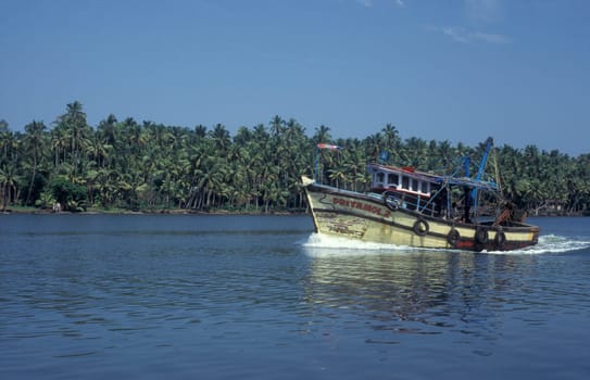a Fishingboat in a Canal in the Lagoons and Backwater at the Coast near the city of Kochi or Cochin in the Province Kerala in India.  India, Cochin, April, 1998