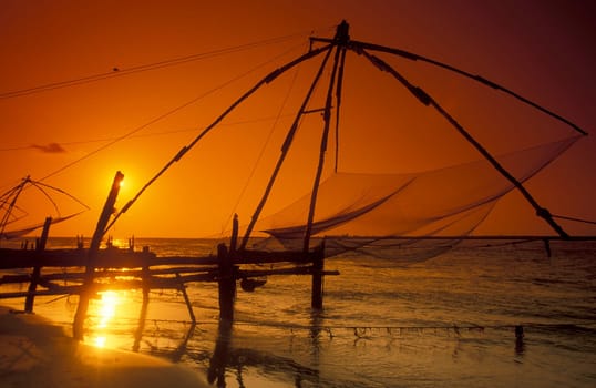 the Chinese Fishing Net by sunset at the Coast in the city of Kochi or Cochin in the Province Kerala in India.  India, Cochin, April, 1998