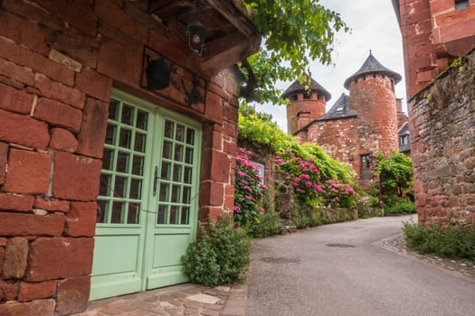 Red houses seen from the street in Collonges-la-Rouge, one of the most beautiful villages in France, Corrèze