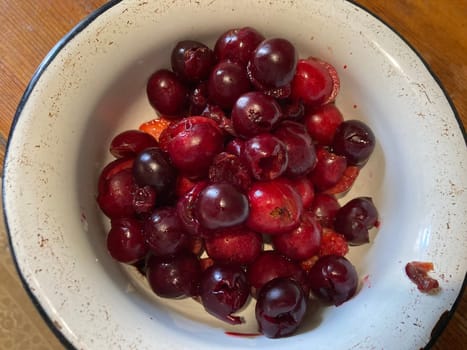Making compote from fresh berries and the fruits