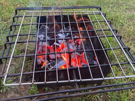 Firewood burning in the a barbecue grill
