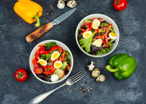 Healthy salad of fresh vegetables, lettuce and quail eggs. Quail eggs salad.