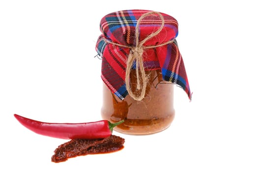 Spicy jar with chilli pepper sauce isolated on white background
