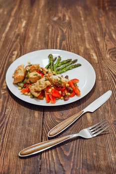 Spicy chicken stew with vegetables and fried asparagus