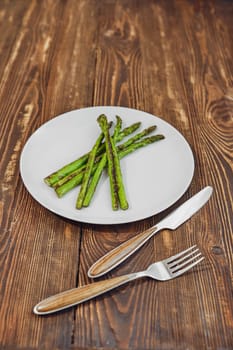 Roasted asparagus with garlic, salt and pepper on a plate