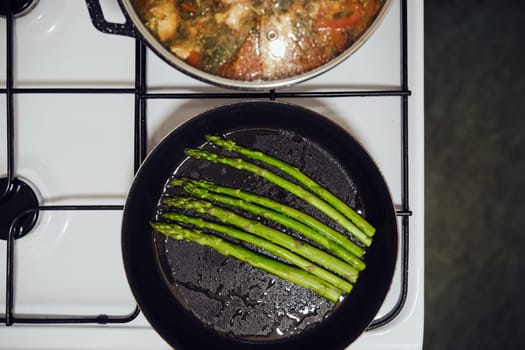 Overhead view of frying pan with spicy asparagus