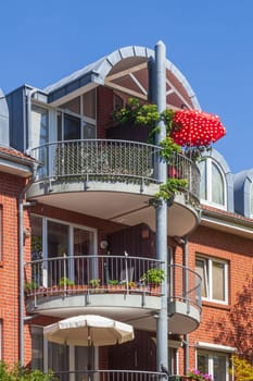 Modern brick residential building with balcony and sunshade, Buxtehude, Lower Saxony, Germany