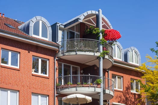 Modern brick residential building with balcony and sunshade, Buxtehude, Lower Saxony, Germany
