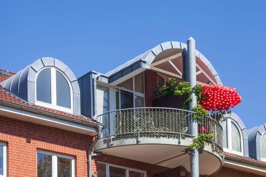 Modern brick residential building with balcony and sunshade, Buxtehude, Lower Saxony, Germany