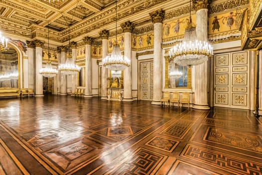 Turin, Italy - 17 november 2023: baroque ballroom interior in Royal Palace, 1842. Luxury marble, antique chandelier, classic floor