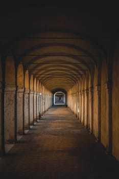 Dark tunnel perspective. Grunge architecture, old corridor in shadow