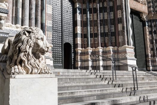 Genoa, Italy - 28 December 2023: the guard lion at the entrance of the Duomo - most important church of the town