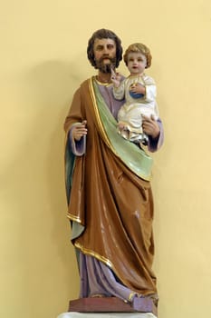 Saint Joseph with baby Jesus, statue in the parish church of Saints Peter and Paul in Kasina, Croatia