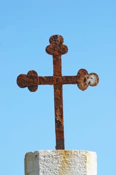 Iron cross in front of the parish church of Saint Jerome in Lun, island of Pag, Croatia
