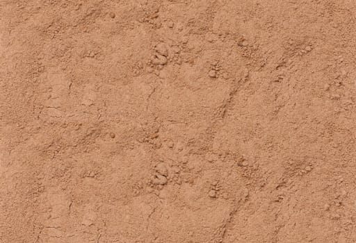 Texture of scattered cocoa powder, full frame. Close up