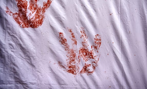 Detail of bloody hand on a wall, death and pain