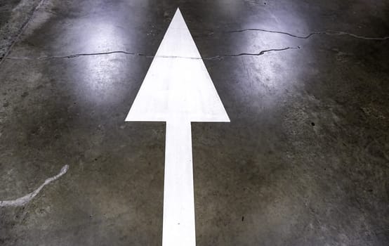 Detail of direction arrow for vehicles in a parking lot