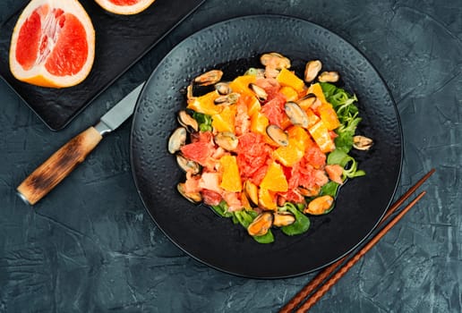 Salad with citrus fruits and mussels, healthy eating. Flat lay