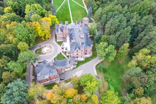 Castle in Moscow in the park. A modern Moscow castle surrounded by trees