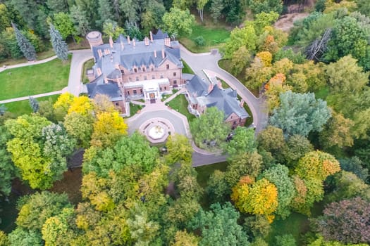 Castle in Moscow in the park. A modern Moscow castle surrounded by trees