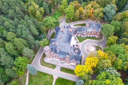Castle in Moscow in the park. A modern Moscow castle surrounded by trees