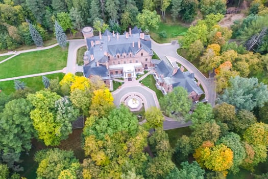 Castle in Moscow in the park. A modern Moscow castle surrounded by trees