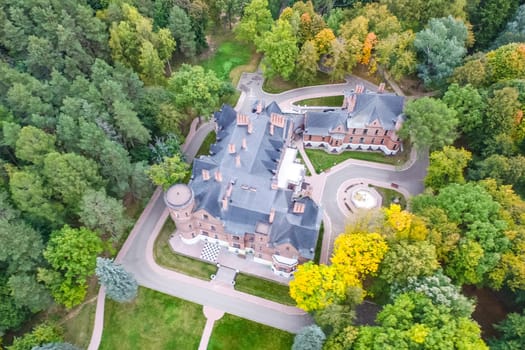 Castle in Moscow in the park. A modern Moscow castle surrounded by trees